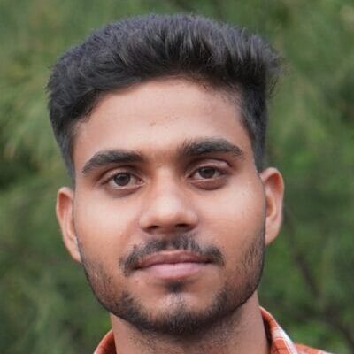 a man in an orange and white checkered shirt