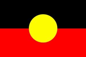 The Aboriginal Flag, featuring a black top half (representing Aboriginal people), a red bottom half (representing the earth/ochre), and a central yellow circle (representing the sun).